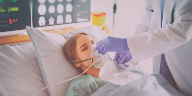 Woman on oxygen in hospital.