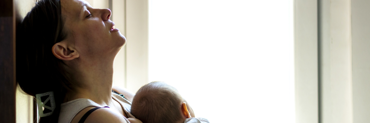 Learning to Ask for Help as the Parent of a Child With a Rare Disease Tired mother rocking sleeping baby.