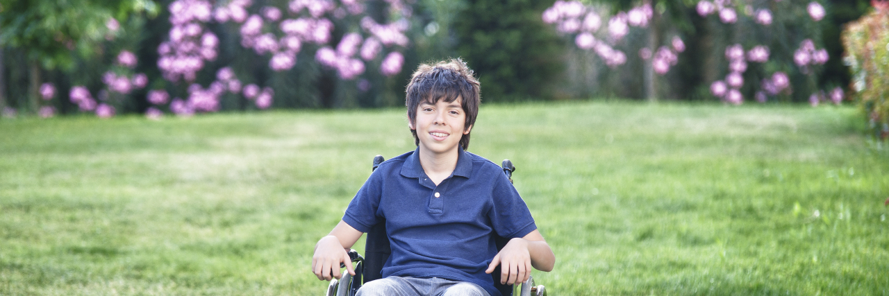 The First Time My Son With Muscular Dystrophy Used a Wheelchair Young boy in a wheelchair outdoors.