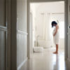 pregnant woman standing in a white bathroom