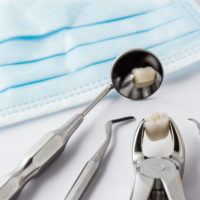 Stainless steel dental tools laying on a counter