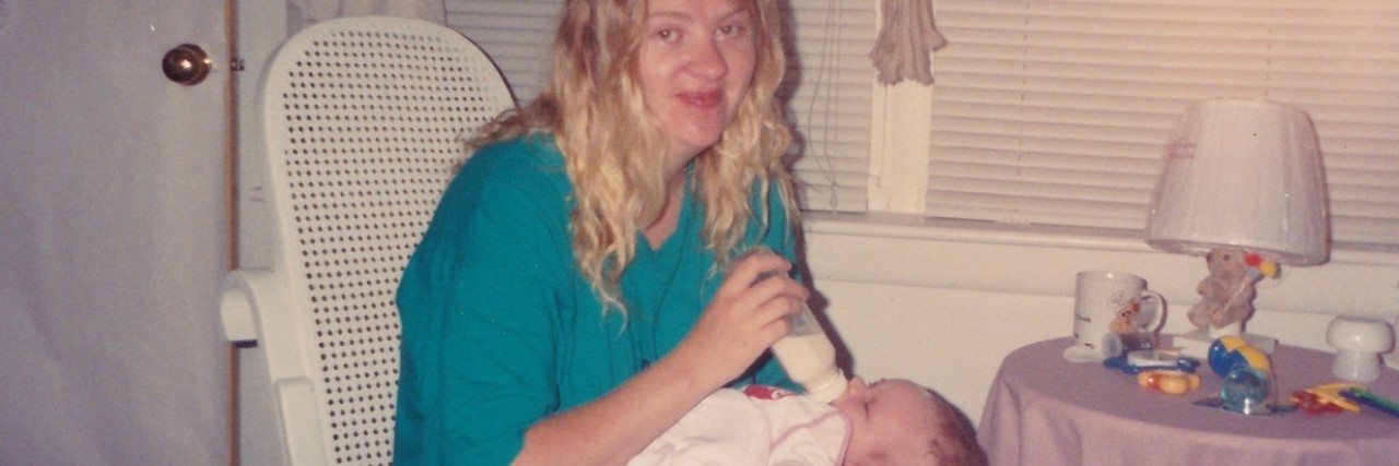 The author feeding her son with a bottle after his hospitalization