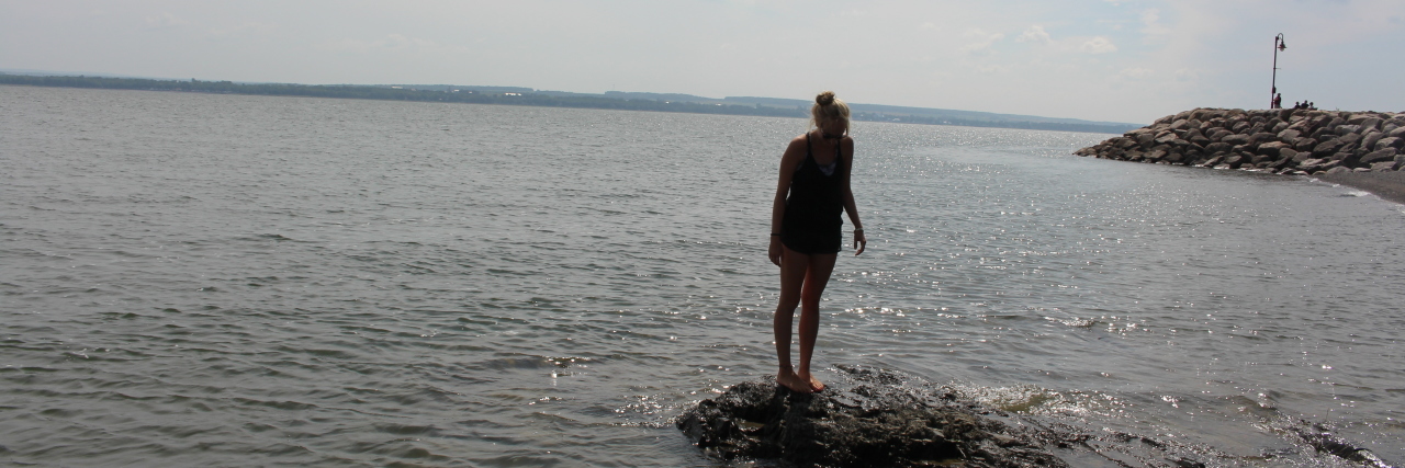 A Life On Hold: a Lyme Disease Story Photo of contributor standing on rocks in the sea