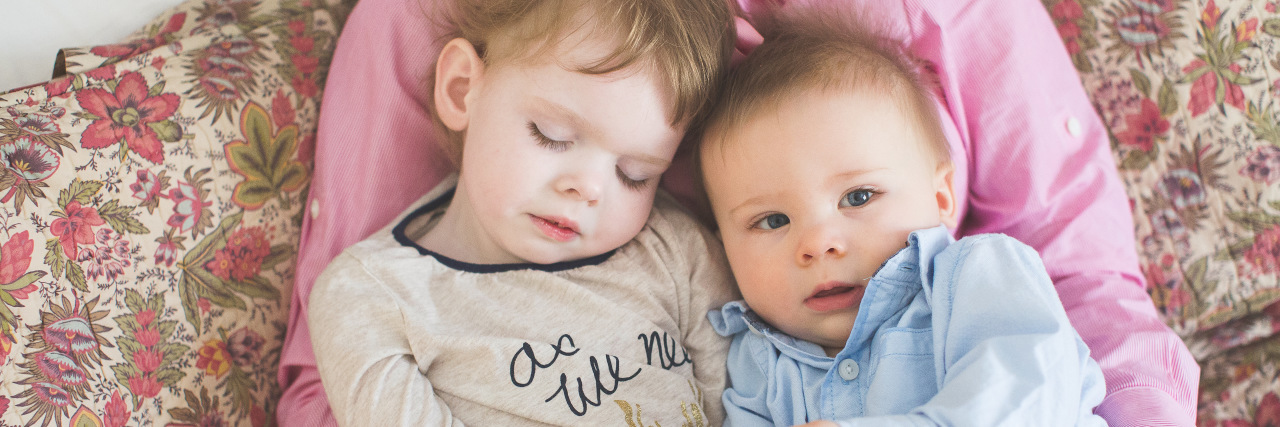 My Bravest Time: Letting June Die a mom cradling her infant and toddler in bed