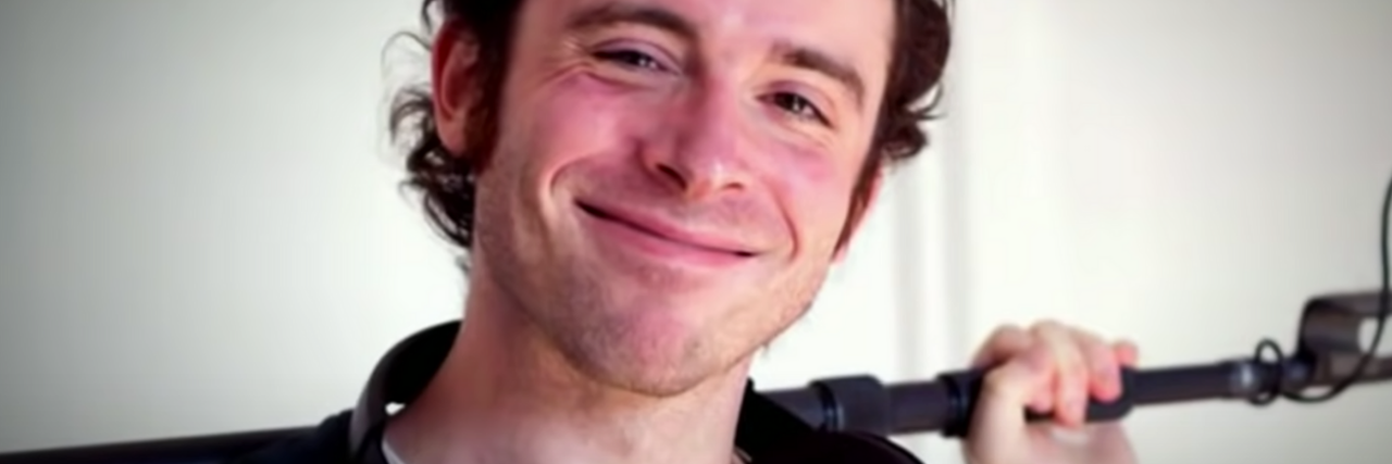 'Nomadland' Wolf Howl: Michael Wolf Snyder, Career Success and Suicide screenshot of sound mixer Michael Wolfe Snyder, smiling for the camera with a mic stand over his shoulders