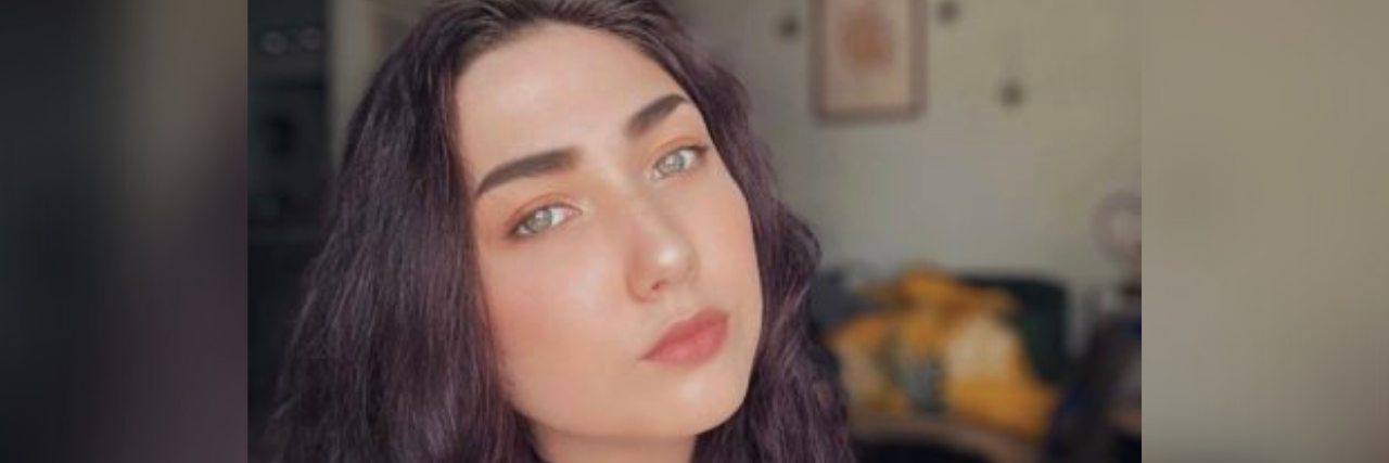 5 Reminders If Your Therapist Breaks Your Trust Selfie of author: A young white woman with purple hair inside, looking carefully