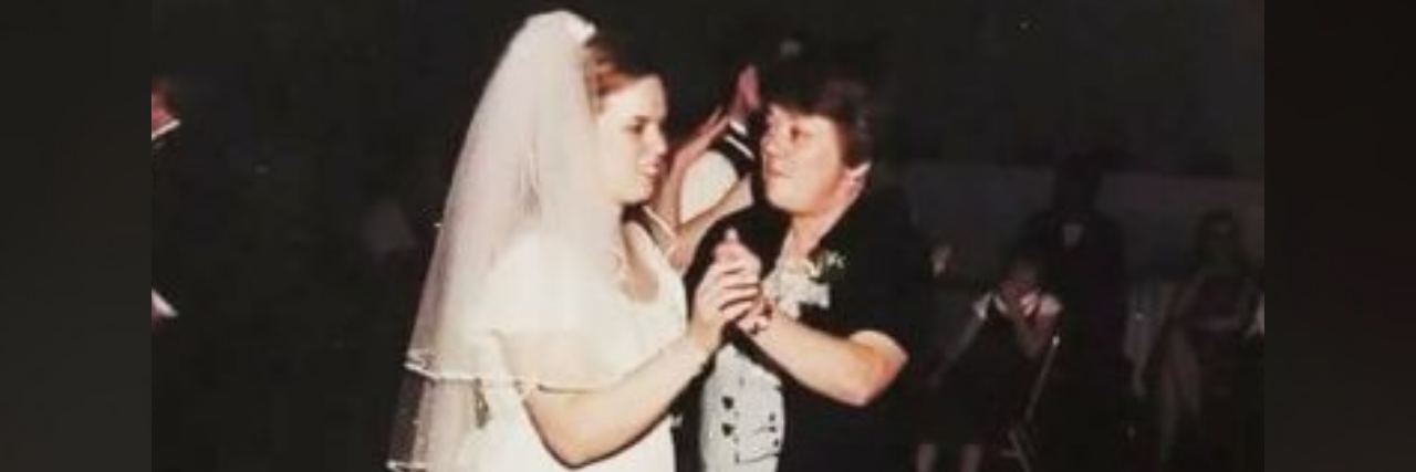 Grief of Setting Boundaries With a Mom Addicted to Drugs and Alcohol Photo of the author, a young white woman on her wedding day, dancing with her mother