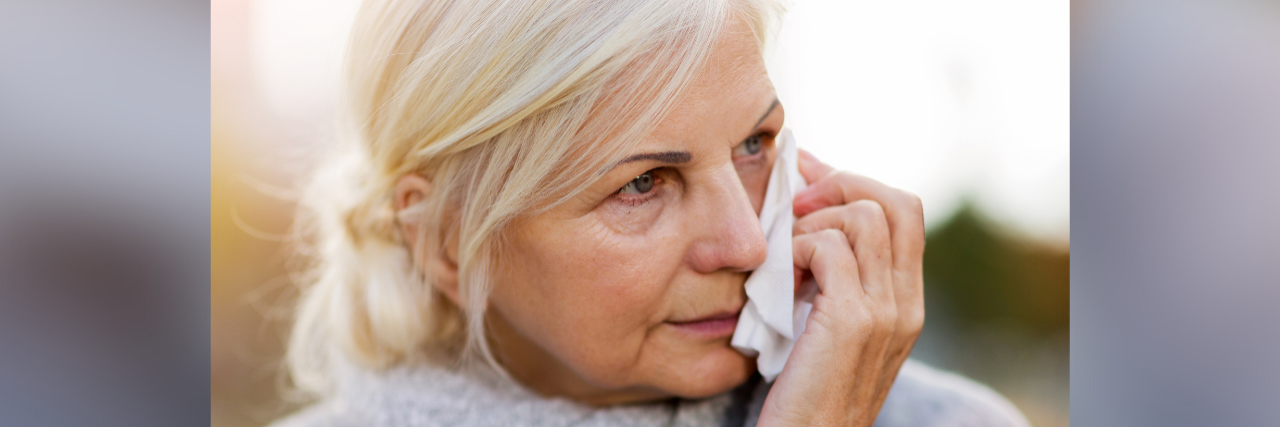I Have Bipolar Depression. Why Can't I Cry? Photo of a mature woman holding a tissue to her face
