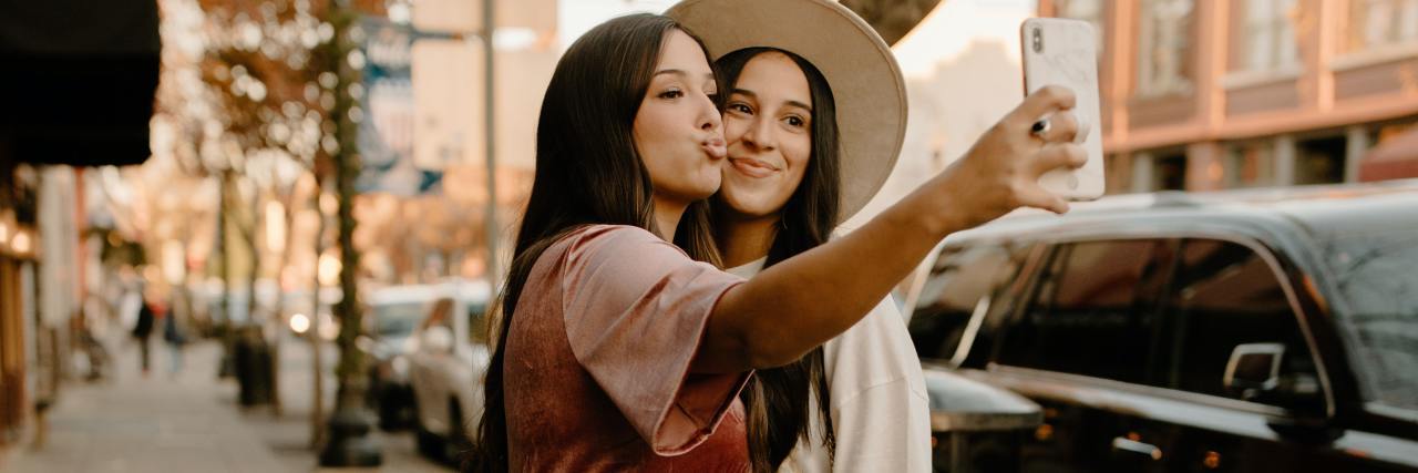 How to Reconnect After Full COVID-19 Vaccination When You Have Anxiety photo of two women taking a selfie together on the street