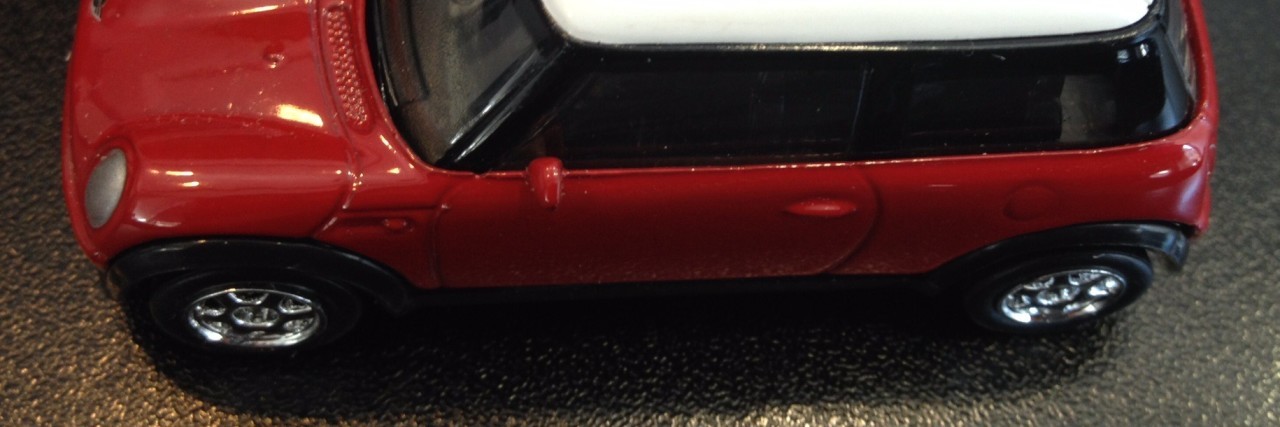 photo of a small red car toy which reads "Center for court innovation" on its roof