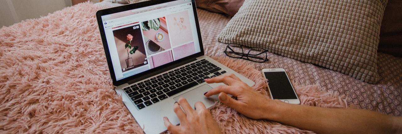 May: Remote Jobs for People With a Disability or Chronic Illness A woman on her computer in bed