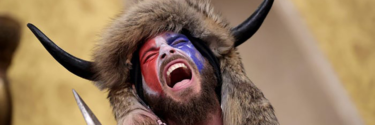 Stop Using Autism as an Excuse for White Supremacy and Violence Jake the "Qanon Shaman" wearing a buffalo hat.