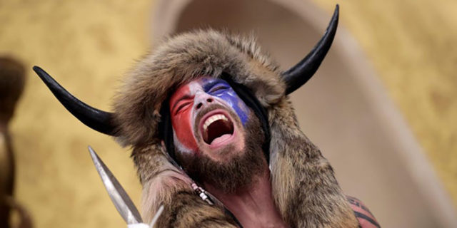 Stop Using Autism as an Excuse for White Supremacy and Violence Jake the "Qanon Shaman" wearing a buffalo hat.