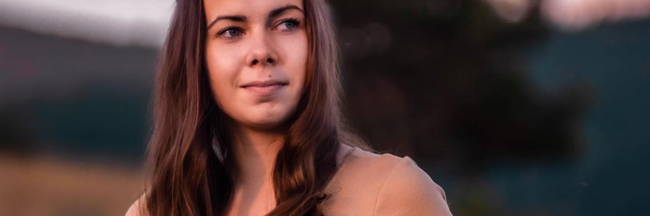 Finding It Hard To Trust New People With Complex PTSD and 'Freeze' photo of a woman in a field at sunset