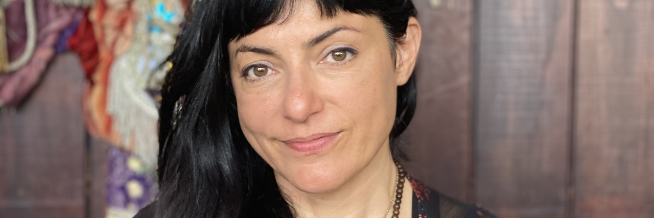 How Dissociation and Compartmentalization Help Kids Cope With Trauma Image of the contributor sitting in front of the camera with a slight smile