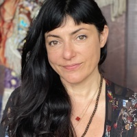 Image of the contributor sitting in front of the camera with a slight smile