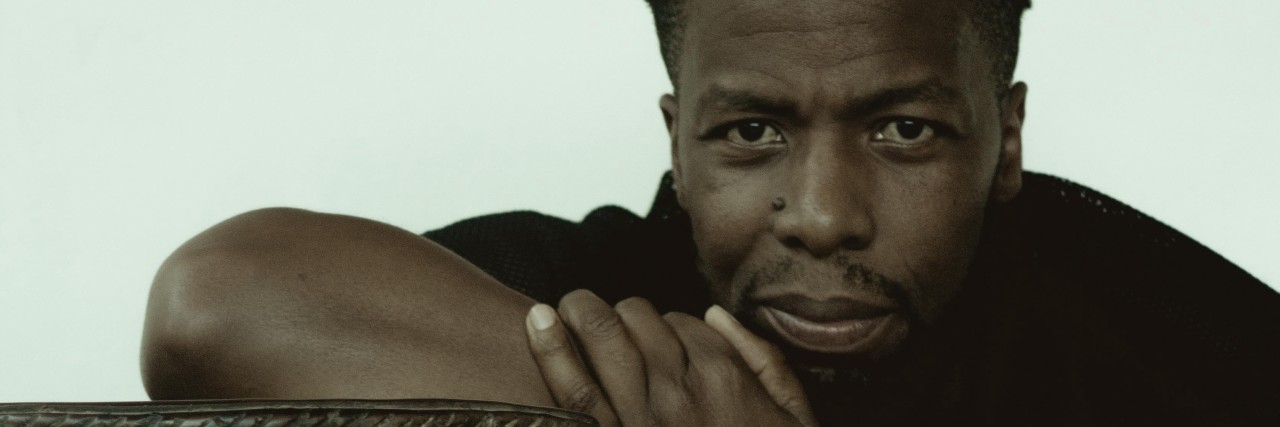 What 5 Years of Living With Multiple Myeloma Have Taught Me Kevin sits with his arm on a table carved into the shape of a human figure.