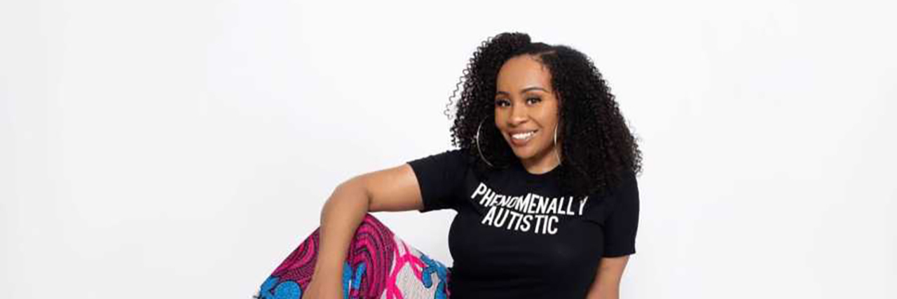 What It Was Like Growing Up Black, Female, Autistic and Undiagnosed Ayanna wearing a Phenomenally Autistic t-shirt and colorful pants.