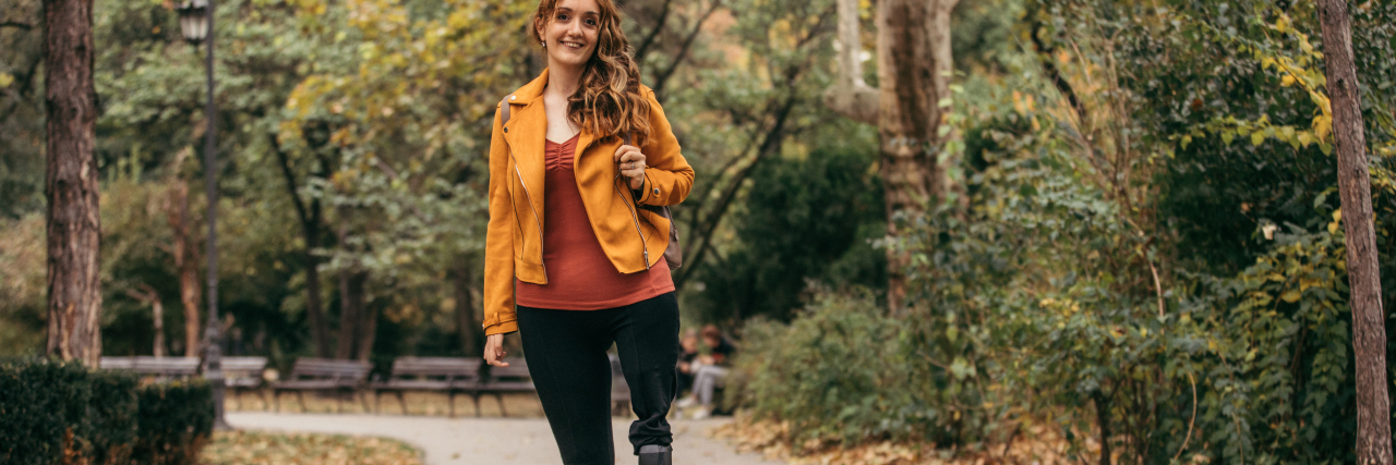 Please Remember: You Could Become Disabled, Too Woman with prosthetic leg standing in the park.
