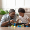 Father playing blocks with son.