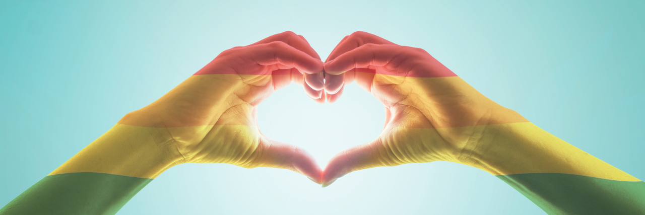 When I Felt Alone as a Young Disabled Lesbian Rainbow hands forming a heart.