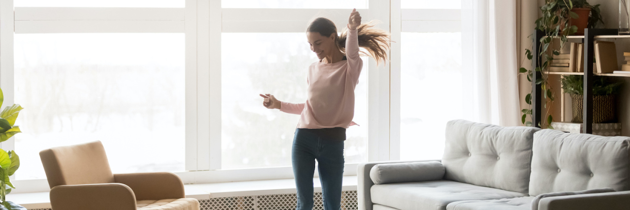 Photo of woman dancing alone at home