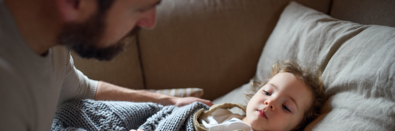 Being the Father My Children Needed as a Man With Chronic Illness Father checking on sleeping daughter.