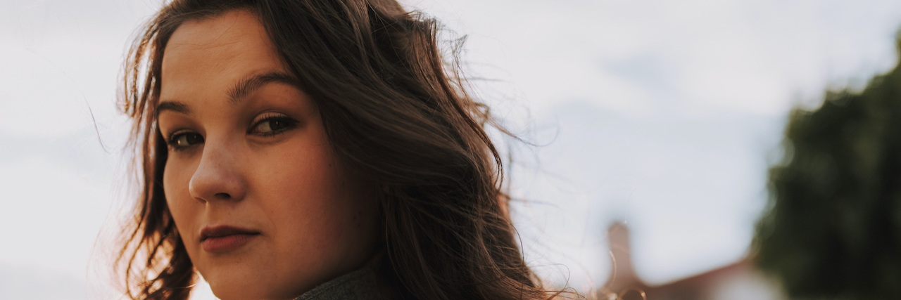 The Slow Process of Going Through Prednisolone Withdrawal Woman standing outside looking confidently at camera