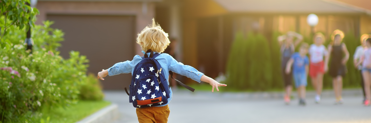 Boy joyfully running to school.