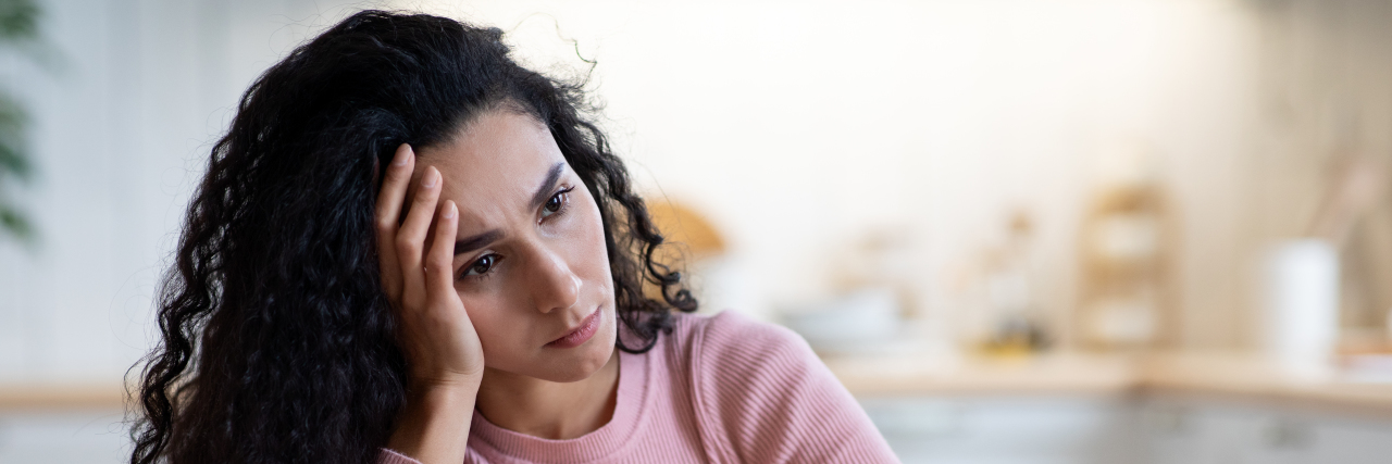 The High Physical and Psychological Cost of Chronic Illness Burnout Sad and stressed woman.