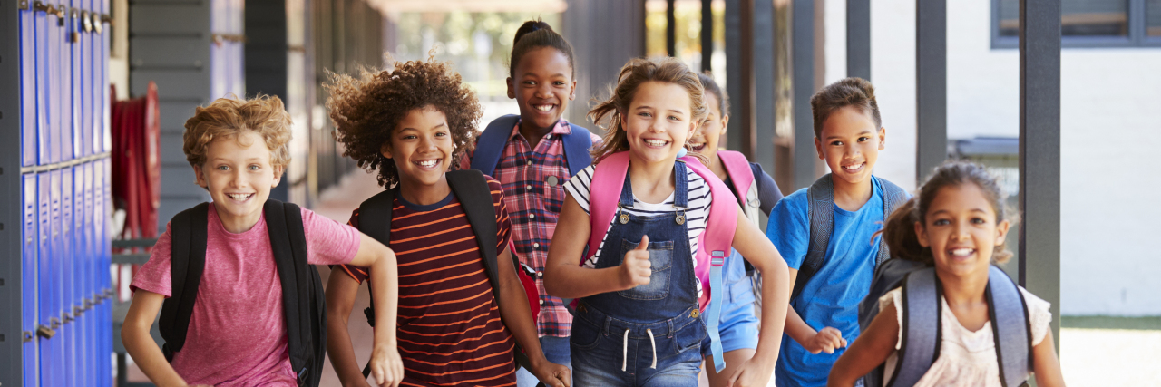 School kids running in elementary school.