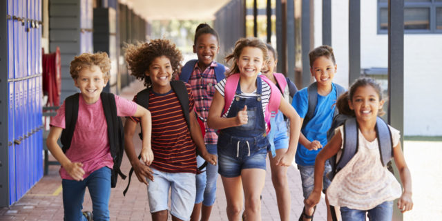 School kids running in elementary school.