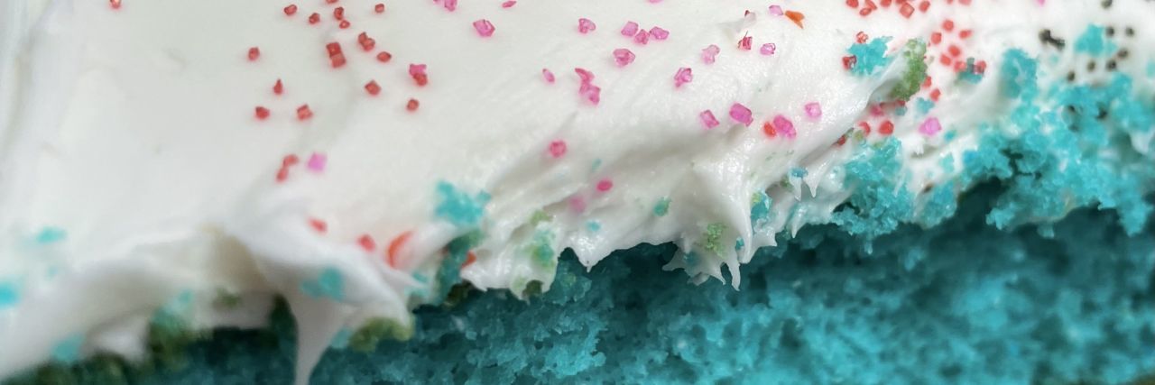 Lisa's cake with blue cake and icing with sprinkles.