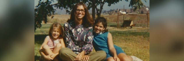 Photo of a young Suz, Linda and Berta sitting outside in the grass