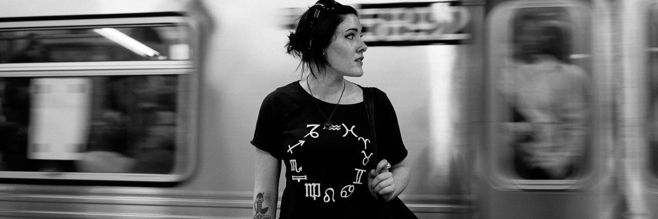 How My Fear of Mental Health Stigma Actually Hurt Me black and white photo of a woman in front of a passing train