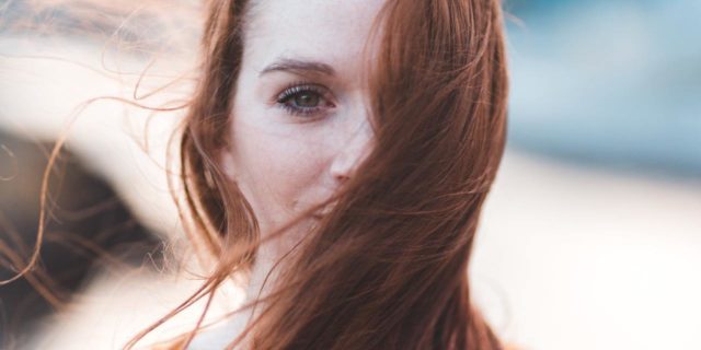 photo of a woman with red hair looking into the camera