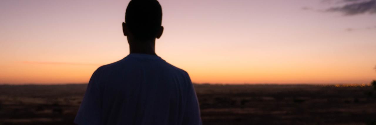 How To Have an Early Warning of Mental Health Struggles photo of a man's silhouette against sunset