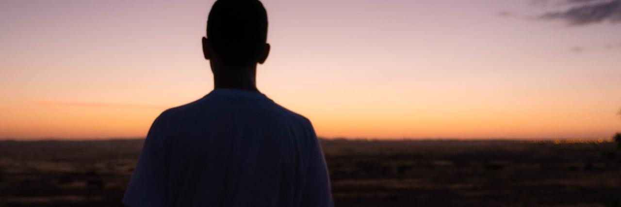photo of a man's silhouette against sunset