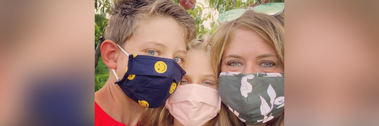 Photo of contributor and her two children posing together and wearing masks