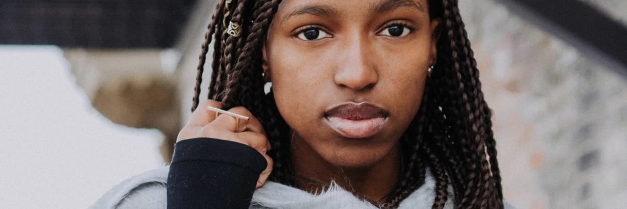 Why My Anxiety Manifests as Negativity and Pessimism photo of a woman looking into the camera with sad or serious expression