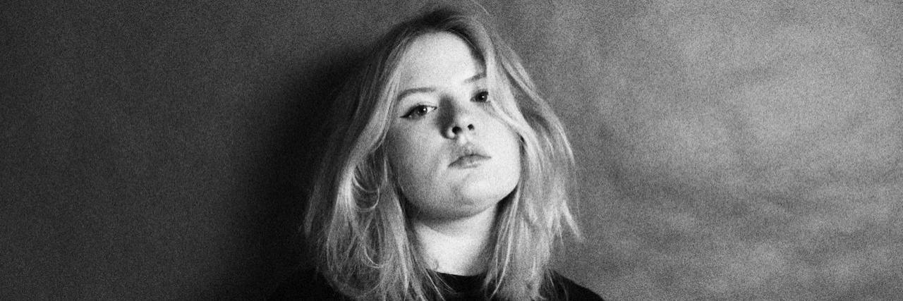 Breaking the Chains of My Eating Disorder Grainy black and white photo of woman looking defiantly at camera