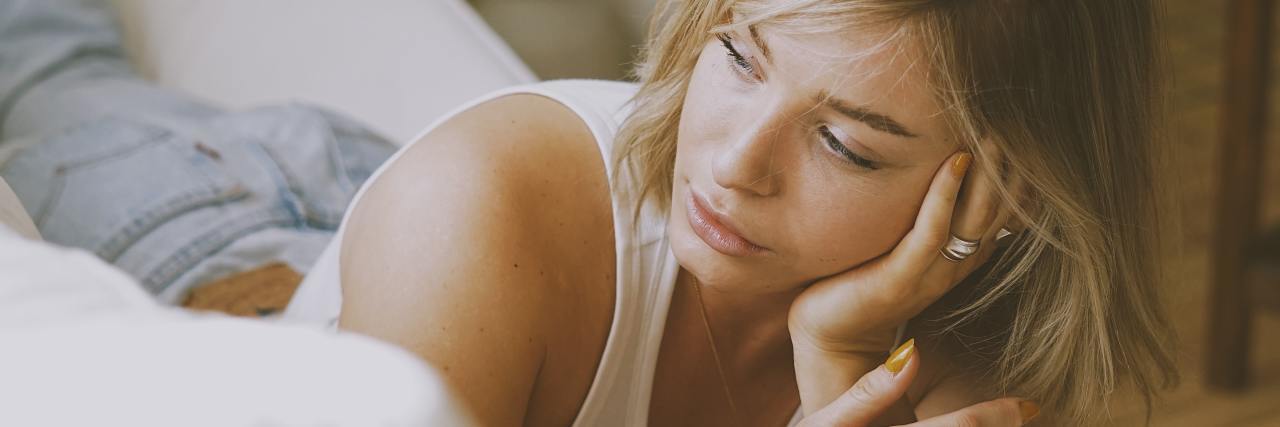 Trauma: What It's Like to Experience 'Maladaptive Daydreaming' photo of a woman lying on a couch daydreaming
