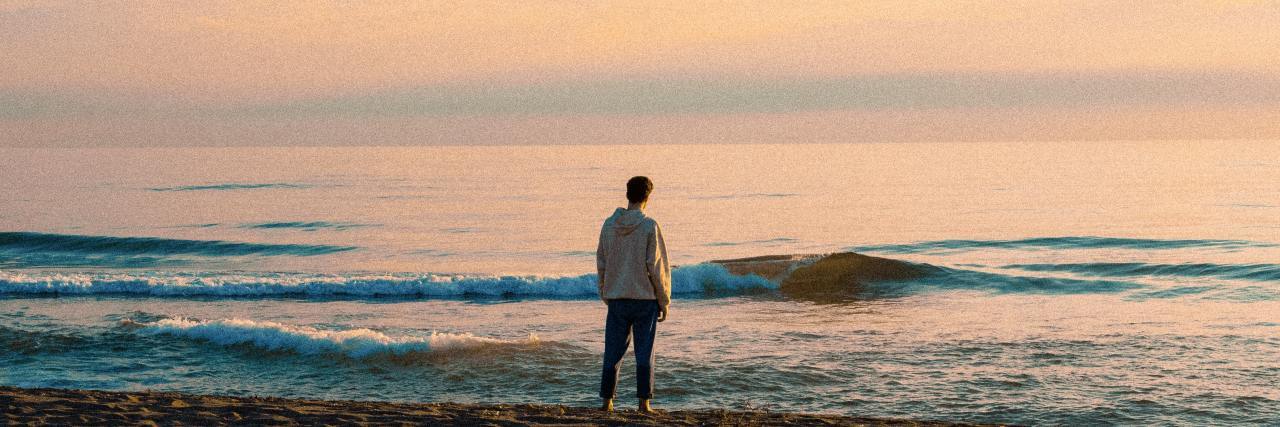 Men Need Help for Borderline Personality Disorder Too photo of a man on a beach shore at sunset looking across ocean