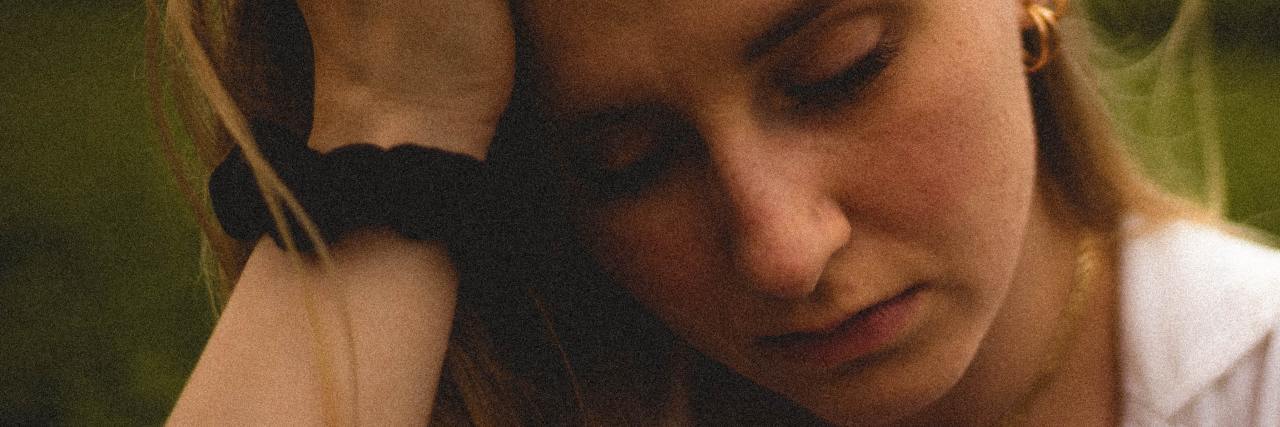 Why It's Important to Have a Psychiatrist Who Is Caring and Listening photo of a woman looking worried or sad with her head resting on her hand
