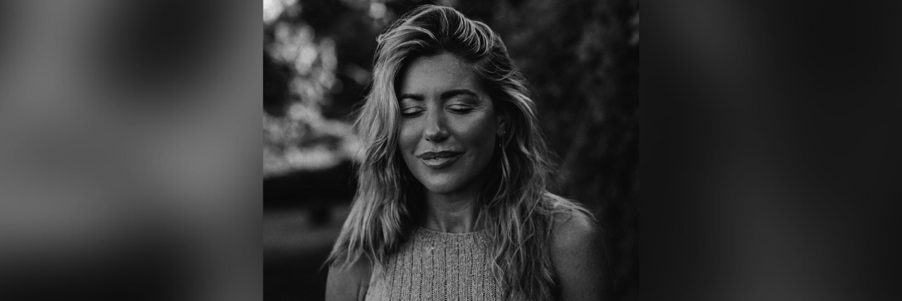 Exploring Holistic Healing and Spirituality After Suicide Loss Black and white photo of the author with her eyes closed and slightly smiling