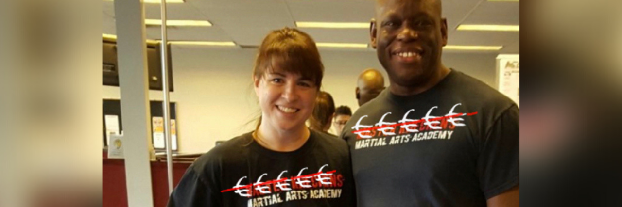 White woman and black man standing together wearing martial arts uniform