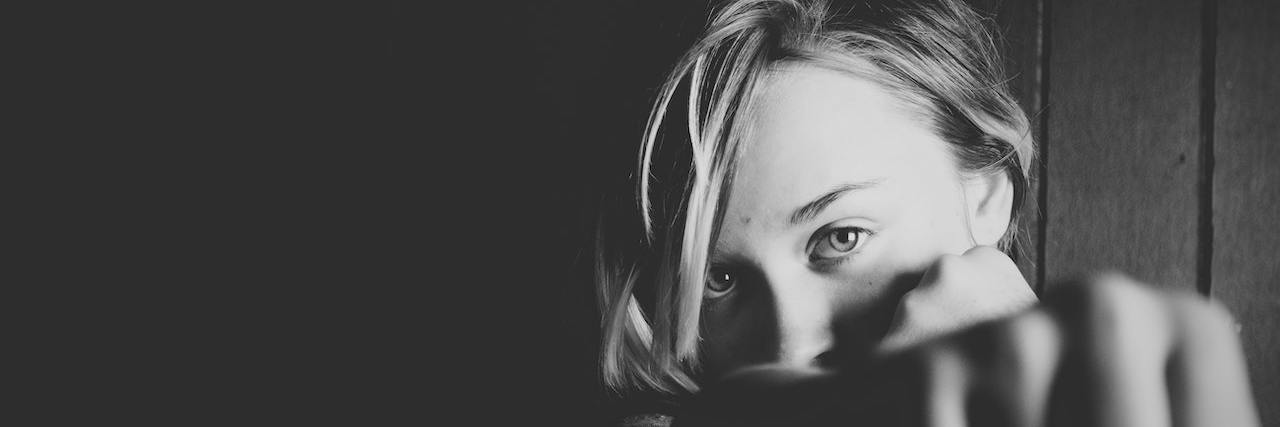 What It's Like Fighting Lyme Disease Against All Odds Black and white photo of woman with fists raised