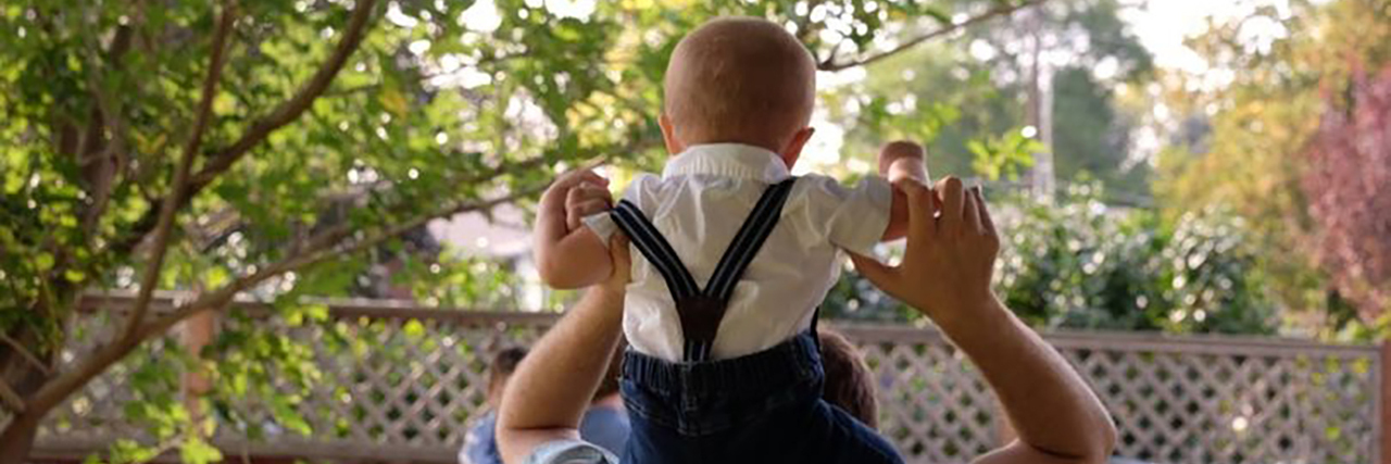 Don't Call the Cops on People for Parenting While Disabled Michael carrying his toddler son on his shoulders.