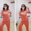 Photo of contributor in her scrubs and giving the peace sign while taking mirror selfies