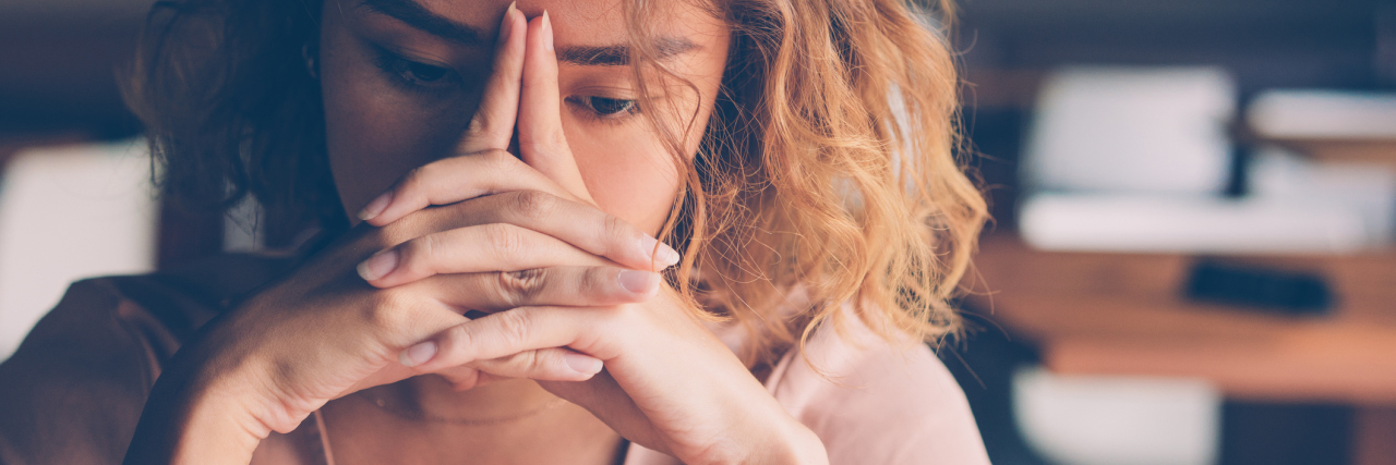 Signs It’s Time to Leave Your Toxic Workplace for Your Mental Health photo of a young woman looking stress, sad or overwhelmed